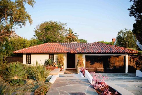 Spanish Style Home - A captivating view of a beautifully designed Spanish-style home with ornate details, terracotta roof tiles, and lush landscaping.